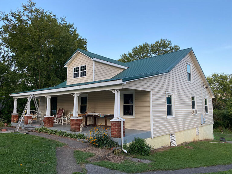 Metal roof installation on a farmhouse by American Home